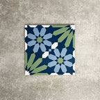 Single Fez Springs 20x20cm Moroccan-style porcelain tile displayed against a textured grey background, highlighting the geometric floral design in layered navy, blue and soft green tones with an encaustic-inspired finish.