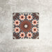 Fez Rosso Moroccan-style porcelain tile shown as a single 20 × 20cm tile, highlighting the intricate geometric pattern in full detail. Deep terracotta and earthy red tones radiate from the centre, layered with soft blush pink star motifs and set against a muted grey background. The balanced, symmetrical design draws inspiration from traditional Moroccan tilework while the porcelain finish keeps it practical and durable. A bold yet elegant choice.