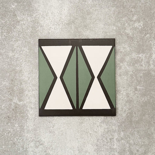 Single Abstract Hourglass Patterned Tile in a 20x20cm format, featuring a bold geometric hourglass design in muted green and soft cream tones with charcoal detailing. A contemporary patterned tile ideal for feature walls, floors or statement splashbacks.
