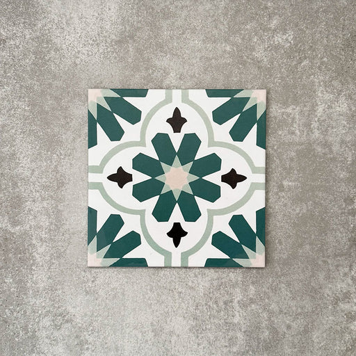 Clara Teal Victorian Moroccan-style porcelain tile in a 20 × 20cm format, shown as a single tile highlighting its teal and green geometric pattern with a decorative encaustic-effect design.