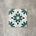 Clara Teal Victorian Moroccan-style porcelain tile in a 20 × 20cm format, shown as a single tile highlighting its teal and green geometric pattern with a decorative encaustic-effect design.
