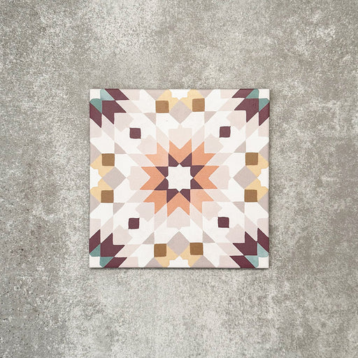 Single Cuba Manzanillo Moroccan-style porcelain tile in a 20×20cm square format, featuring a geometric star motif in soft cream, mustard, teal and burgundy tones, shown against a neutral background to highlight the tile’s crisp detailing and decorative encaustic-style design.