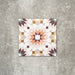 Single Cuba Manzanillo Moroccan-style porcelain tile in a 20×20cm square format, featuring a geometric star motif in soft cream, mustard, teal and burgundy tones, shown against a neutral background to highlight the tile’s crisp detailing and decorative encaustic-style design.