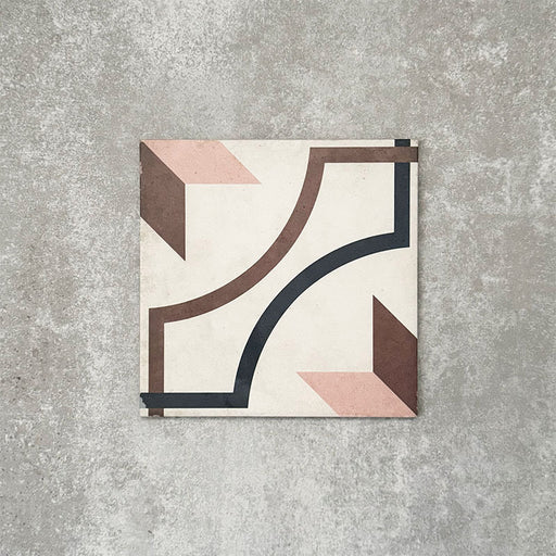 Viscount Rose 20×20cm Victorian-style porcelain wall and floor tile featuring a geometric pattern with curved lines and angular motifs in soft rose, warm brown and deep navy, photographed as a single tile on a neutral grey background.