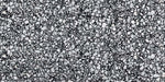 Close-up of Shards Terrazzo Nero 59x118cm matt porcelain wall and floor tile, showcasing a bold black base with varied white aggregate pieces, creating a striking terrazzo effect with natural variation and texture.