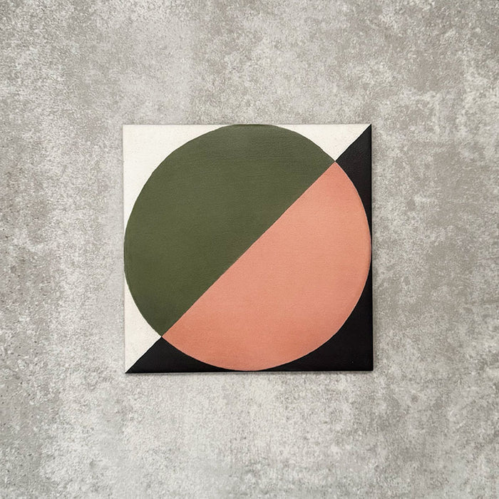 Single Abstract Moon Patterned Tile in a 20x20cm format, featuring a bold geometric circular design with contrasting green and soft blush tones, accented by black corner details on a neutral background. A contemporary patterned tile ideal for feature walls, floors or statement splashbacks.