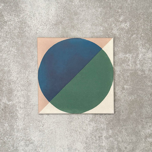 Single Abstract Ocean Patterned Tile in a 20x20cm format, featuring a bold geometric circular design with deep blue and rich green tones, framed by soft neutral corners. A contemporary patterned tile ideal for feature walls, floors or statement splashbacks.