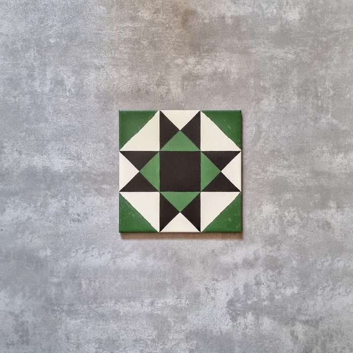 Single Greenbrook Manor anti-slip encaustic Victorian-style porcelain tile, 20 × 20 cm, featuring a bold geometric star pattern in green, black and white on a neutral background.