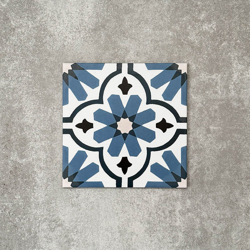 Clara Azul Victorian Moroccan-style porcelain tile in a 20 × 20cm format, shown as a single tile highlighting its blue and white geometric pattern with a decorative encaustic-effect design.