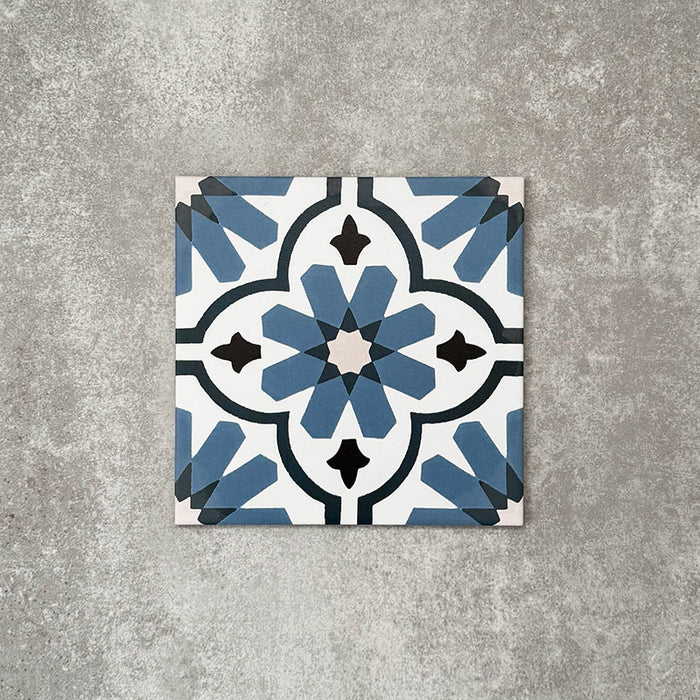 Clara Azul Victorian Moroccan-style porcelain tile in a 20 × 20cm format, shown as a single tile highlighting its blue and white geometric pattern with a decorative encaustic-effect design.