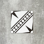 Gilgamesh Blanco Vintage White Moroccan style 20x20cm patterned tile, shown as a single tile highlighting the white and black geometric star design.