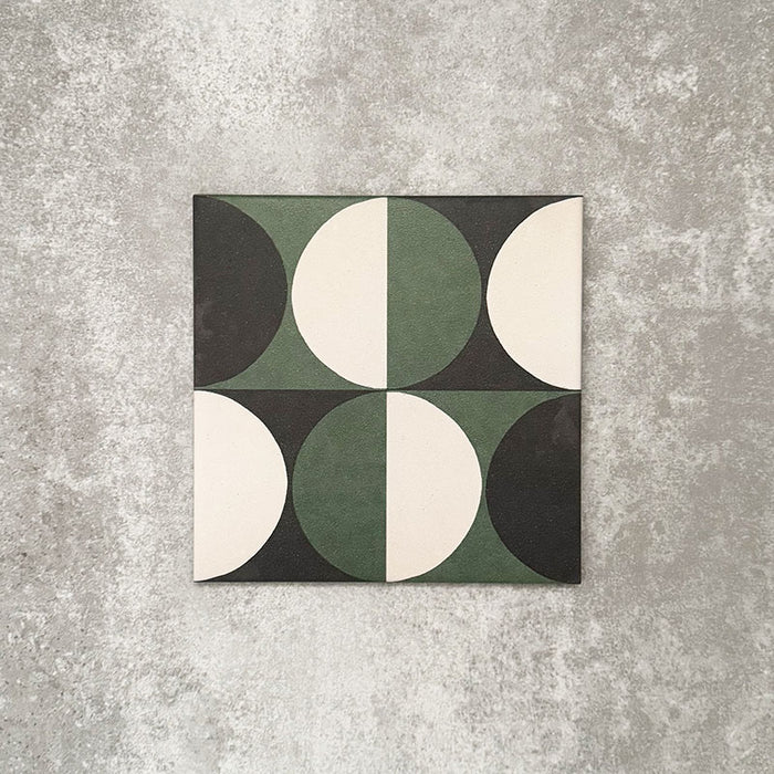 Single Abstract Circles Patterned Tile in a 20x20cm format, featuring a bold geometric design with alternating circular segments in deep green, charcoal and soft cream tones. A contemporary patterned tile ideal for feature walls, floors or statement splashbacks.