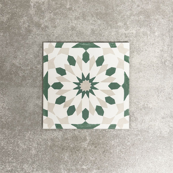 Souk Green A 20×20cm Moroccan-style porcelain tile with a green, white and beige geometric pattern.
