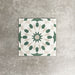 Souk Green A 20×20cm Moroccan-style porcelain tile with a green, white and beige geometric pattern.