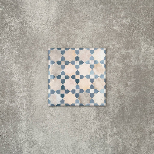 Berber Mequinez Blue 15×15cm Moroccan-style porcelain tile featuring a blue and cream geometric pattern on a neutral background.