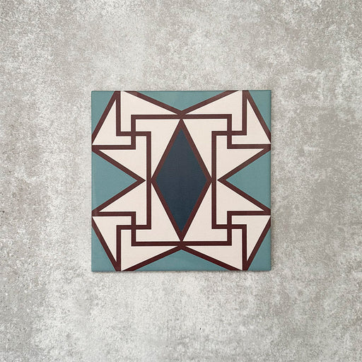 Single Abstract Iris Patterned Tile in a 20x20cm format, featuring an intricate geometric design with a central diamond motif in deep blue, framed by soft cream, teal and fine red detailing. A bold, decorative patterned tile ideal for feature walls, floors or statement splashbacks.