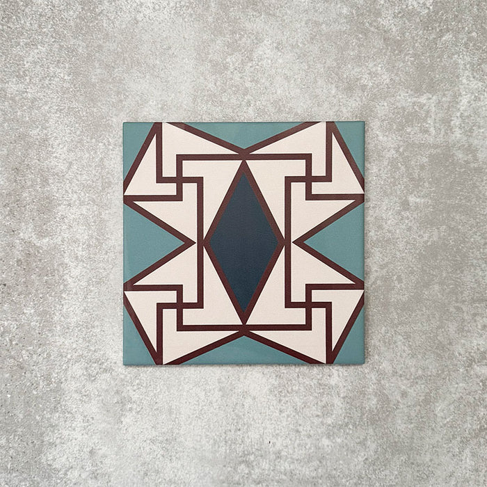 Single Abstract Iris Patterned Tile in a 20x20cm format, featuring an intricate geometric design with a central diamond motif in deep blue, framed by soft cream, teal and fine red detailing. A bold, decorative patterned tile ideal for feature walls, floors or statement splashbacks.