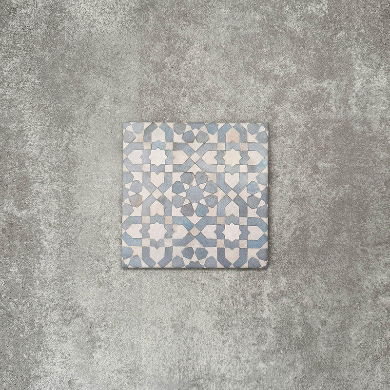 Berber Tetuan Blue 15×15cm Moroccan-style porcelain tile featuring a soft blue and cream geometric pattern on a neutral background.