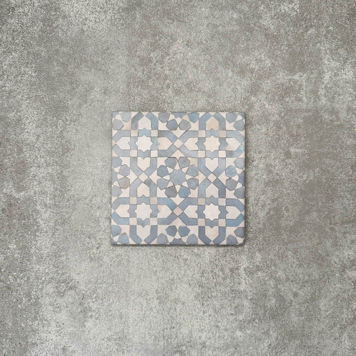 Berber Tetuan Blue 15×15cm Moroccan-style porcelain tile featuring a soft blue and cream geometric pattern on a neutral background.
