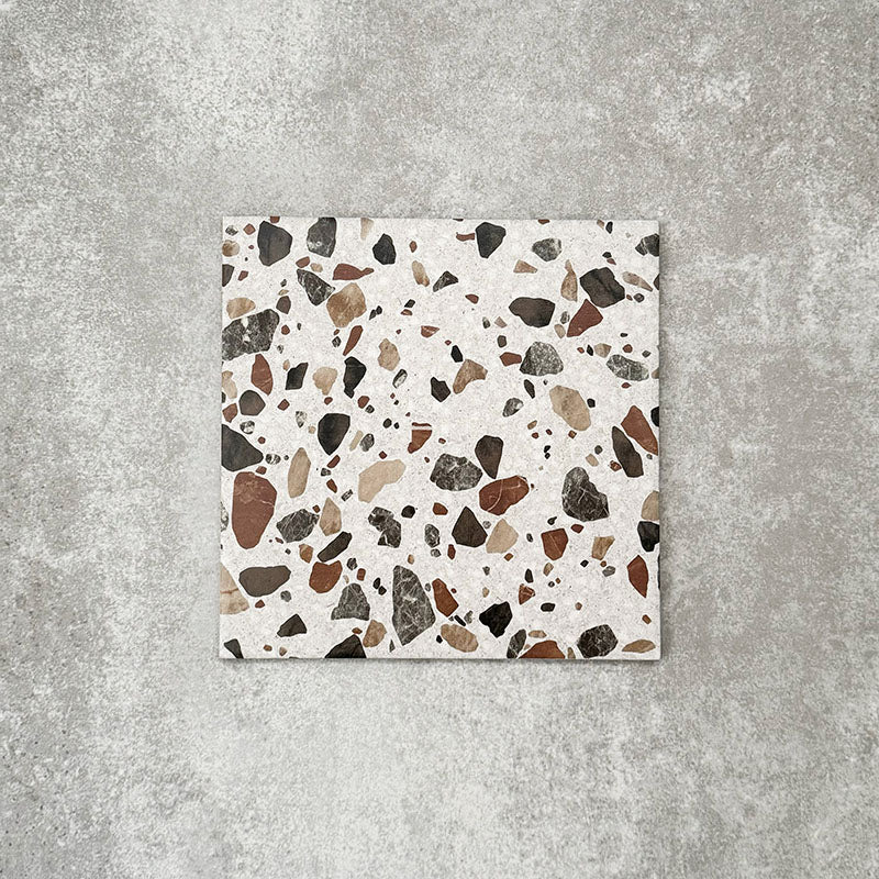 Single Turin Terrazzo Blanco Drops porcelain tile in a 20 × 20cm format, featuring a terrazzo-style design with larger scattered stone fragments in warm neutral tones on a light base, shown on a neutral background to highlight the texture and pattern suitable for wall and floor use.