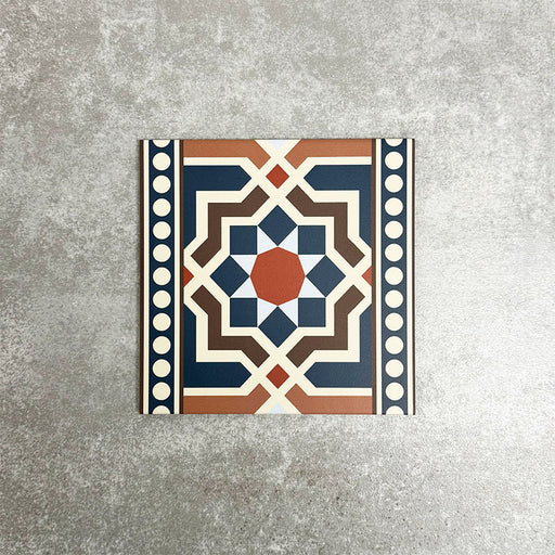 Single Balthazar Grand Side 20×20cm porcelain tile displayed against a neutral stone-effect background, featuring a bold Moroccan-inspired geometric border design in deep blue, warm brown, terracotta and cream tones, ideal for use as a decorative feature or edging tile.