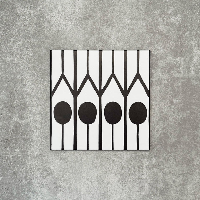 Single Almeria Felis Moroccan-style porcelain tile featuring a black and white geometric dot and line pattern, 20x20cm, suitable for wall and floor use.