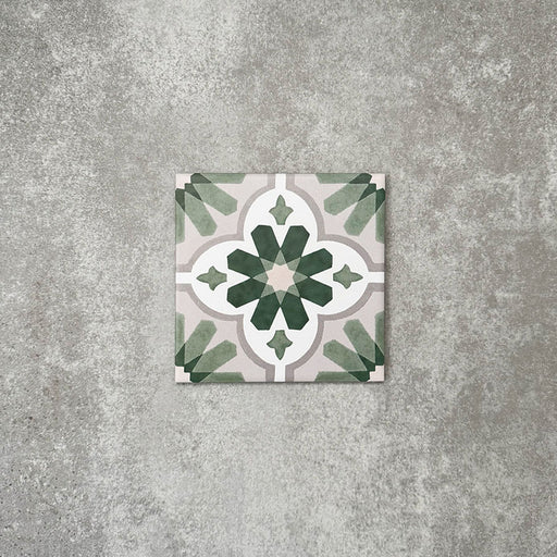 Clara Jade Mini Victorian Moroccan-style porcelain tile in a 15 × 15cm format, shown as a single tile highlighting its green geometric pattern and decorative encaustic-effect design.