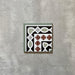 Single Imperial Victorian Green Mini Corner Tile, 15x15cm porcelain tile featuring a classic Victorian-inspired corner pattern in green, black, white, and terracotta tones, photographed on a neutral background.