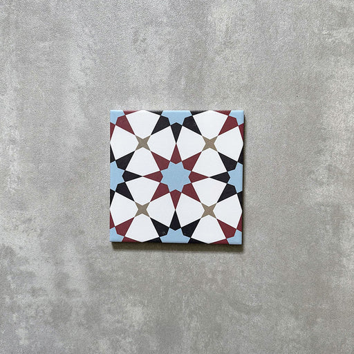 Agadir Atlas Mini Moroccan-style 15x15cm porcelain tile featuring a geometric star pattern in soft blue, burgundy, black and cream, shown as a single tile on a neutral background.