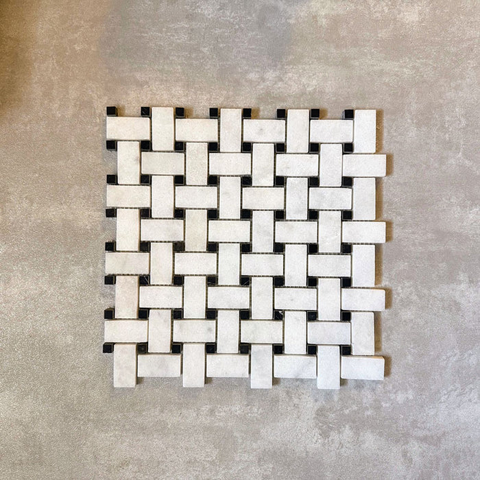Single Fayrouz Black & White basketweave mosaic natural marble tile with a honed finish, featuring an intricate woven pattern with contrasting dark accents, displayed against a neutral textured background in a clean product setting.