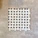 Single Fayrouz Black & White basketweave mosaic natural marble tile with a honed finish, featuring an intricate woven pattern with contrasting dark accents, displayed against a neutral textured background in a clean product setting.