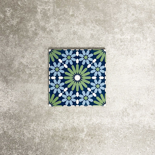 Single Fez Mini Springs 15x15cm Moroccan-style porcelain tile displayed against a textured grey background, highlighting the layered blue and soft green geometric star pattern with an encaustic-inspired finish.