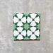 Agadir Green Moroccan-style 20x20cm porcelain tile featuring a geometric star pattern in soft green and white, shown as a single tile on a neutral background.