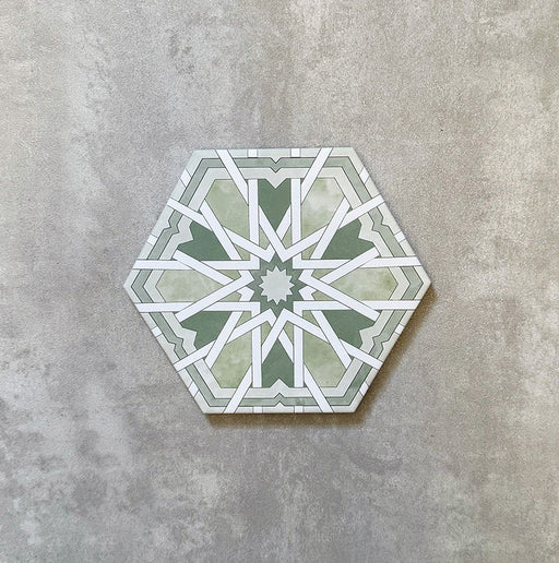 Single Medina Hormuz Verde Green Moroccan-style hexagon porcelain tile, 18.7 × 21.6 cm, featuring a bold star-inspired geometric pattern in green and white tones on a neutral background.
