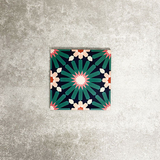 Single Fez Mini Festival 15x15cm Moroccan-style porcelain tile displayed against a textured grey background, highlighting the bold multicolour geometric star pattern in teal, pink and warm neutral tones.