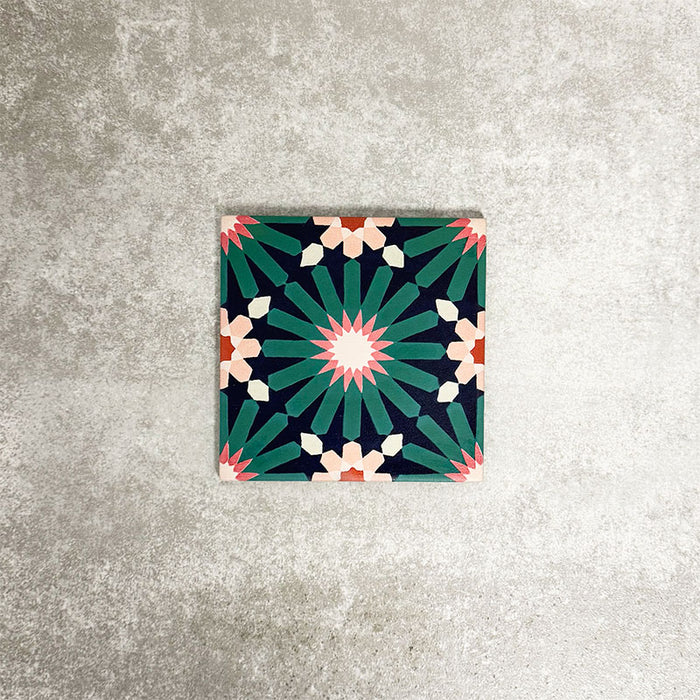 Single Fez Mini Festival 15x15cm Moroccan-style porcelain tile displayed against a textured grey background, highlighting the bold multicolour geometric star pattern in teal, pink and warm neutral tones.