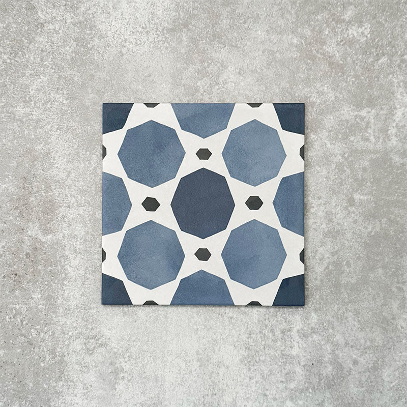 Viscount Sapphire 20×20cm Victorian-style porcelain wall and floor tile featuring a blue and white geometric pattern with octagonal motifs, photographed as a single tile on a neutral grey background.