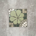 Single Nantes Green Moroccan-style tile in a 20x20cm format, featuring a floral-inspired motif in soft green tones with mosaic-style detailing in muted neutrals and white. A decorative patterned tile ideal for feature walls, floors or statement splashbacks.