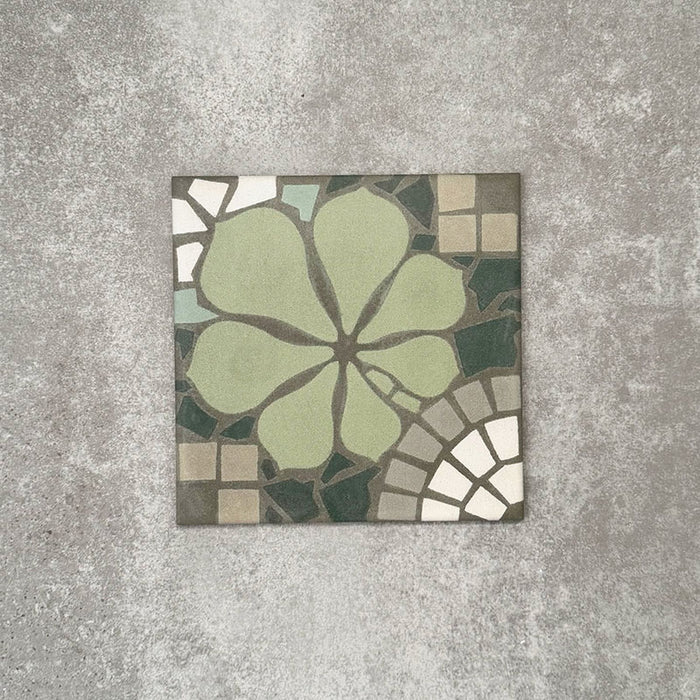 Single Nantes Green Moroccan-style tile in a 20x20cm format, featuring a floral-inspired motif in soft green tones with mosaic-style detailing in muted neutrals and white. A decorative patterned tile ideal for feature walls, floors or statement splashbacks.