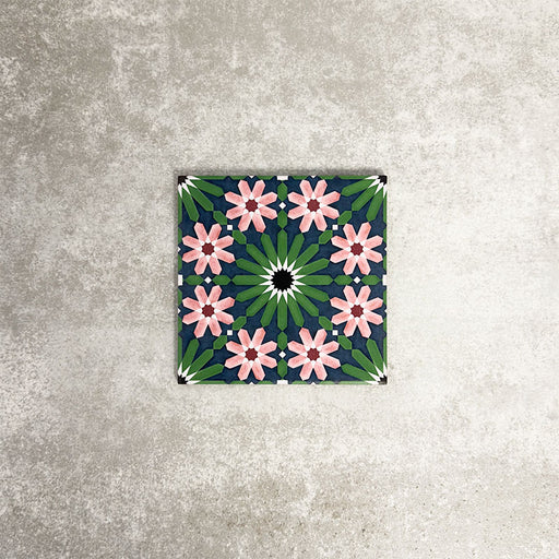 Fez Mini Autumn Moroccan-style porcelain tile shown as a single tile, featuring an intricate geometric star pattern in deep green, soft blush pink, charcoal and white. The 15 × 15cm tile highlights the detailed encaustic-effect design and rich autumnal colour palette, ideal for adding decorative interest to walls or floors.