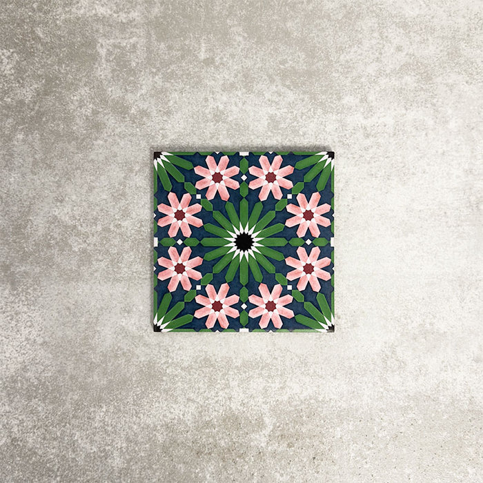 Fez Mini Autumn Moroccan-style porcelain tile shown as a single tile, featuring an intricate geometric star pattern in deep green, soft blush pink, charcoal and white. The 15 × 15cm tile highlights the detailed encaustic-effect design and rich autumnal colour palette, ideal for adding decorative interest to walls or floors.