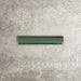 Pimlico Golders Green pencil trim tile measuring 2.5 × 15cm, finished with a crackle glaze and deep green tone, designed to neatly frame ceramic wall tiles and add a subtle decorative edge.
