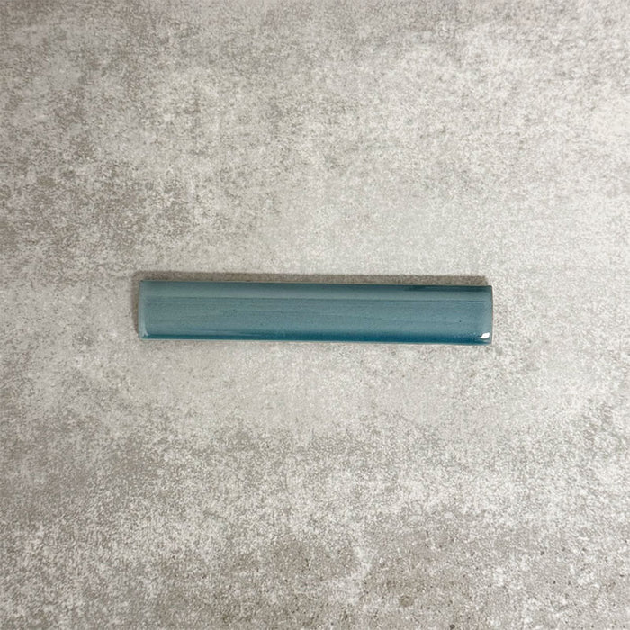 Pimlico River Blue pencil trim tile measuring 2.5 × 15cm, finished with a crackle glaze and rich blue tone, designed to neatly frame ceramic wall tiles and add a subtle decorative edge.