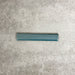 Pimlico River Blue pencil trim tile measuring 2.5 × 15cm, finished with a crackle glaze and rich blue tone, designed to neatly frame ceramic wall tiles and add a subtle decorative edge.