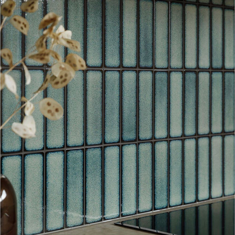 Kitchen splashback featuring Alchemy Hunter Green 6.5×30cm ceramic wall tiles with a glossy green finish.