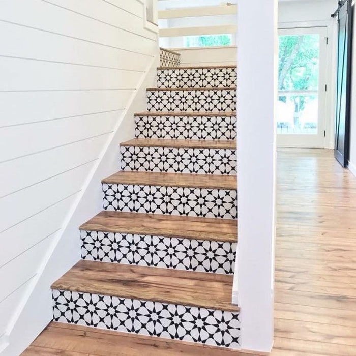 Staircase featuring Agadir Black & White Mini Moroccan-style 15x15cm porcelain tiles on the risers, showcasing a bold geometric star pattern, paired with natural wooden treads for a striking contrast.