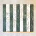 Arrangement featuring Fayrouz Calacatta Green 5x20cm natural marble tiles with a honed finish, displayed in a striped layout alternating green and white marble pieces to highlight natural veining and tonal variation against a neutral backdrop.