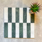 Arrangement featuring Fayrouz White 5x20cm natural marble tiles with a honed finish, paired with green marble pieces in a striped layout, highlighting soft white tones with subtle grey veining alongside rich green variation for contrast and visual interest.