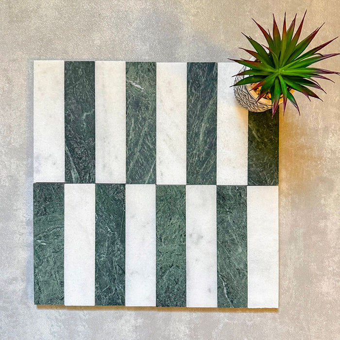 Arrangement featuring Fayrouz White 5x20cm natural marble tiles with a honed finish, paired with green marble pieces in a striped layout, highlighting soft white tones with subtle grey veining alongside rich green variation for contrast and visual interest.