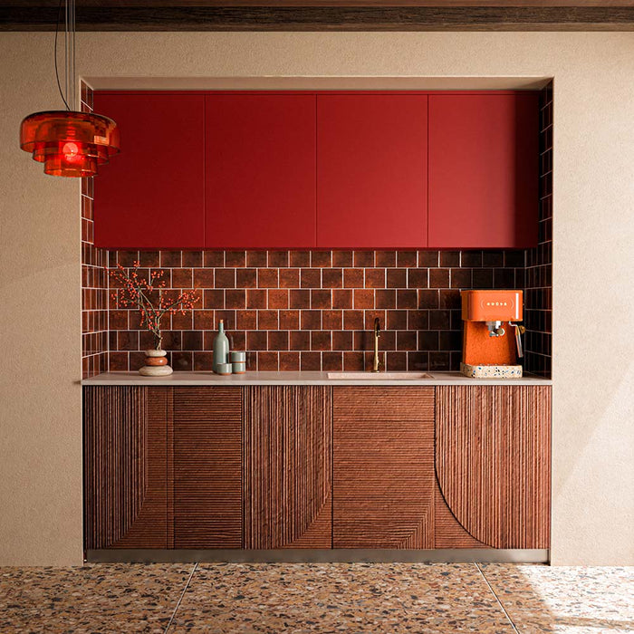 Stuzzi Amber 60cm x 120cm terrazzo effect tiles with a 4D brushed finish, bringing warm amber and earthy tones to the floor, paired with rich red cabinetry and deep brown wall tiles.